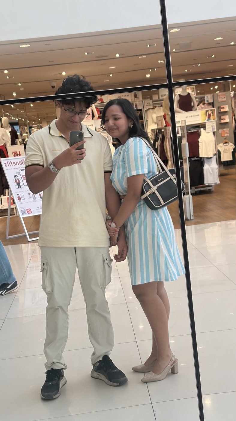 Us holding hands in a mirror selfie